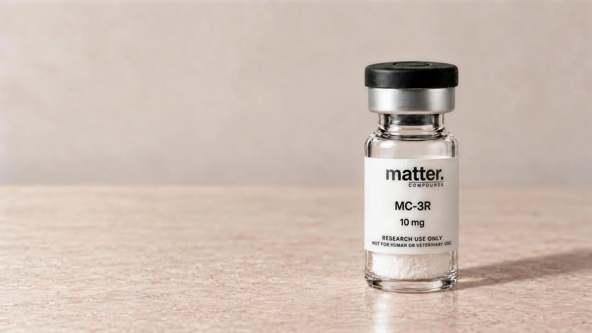 Matter Compounds MC-3R research vial with a black closure on pale limestone